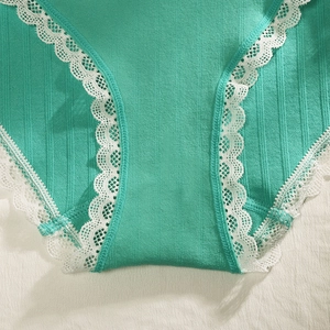 Mint green ribbed cotton panties for women with white lace trim details and seamless design