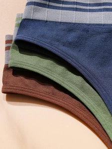 Close-up of seamless ribbed waistband on soft navy, olive green, and brown cotton briefs