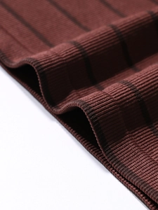 Close-up of dark red ribbed knit fabric with seamless texture and fine edge stitching