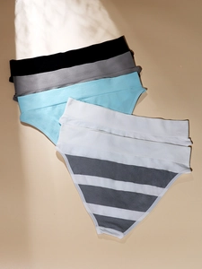 Detailed stack of five seamless high-waisted Brazilian panties in assorted colors and patterns