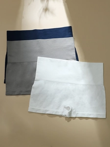 Three-pack seamless high-waist safety shorts in navy, grey, and white with leaf shadows