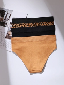 Seamless knitted leopard print and solid panties set on a white surface with magazine