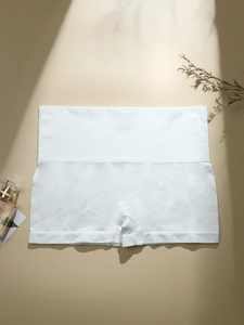 Detail of white seamless high-waist safety shorts with soft knit texture and elastic fit