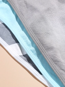 Close-up of fine flatlock stitching and diverse fabric textures on seamless underwear