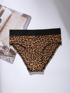 Detail view of leopard print cotton panties with a black elastic waistband on white