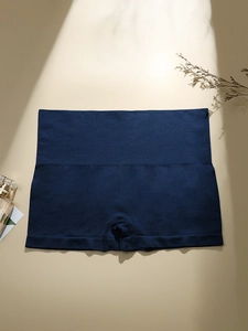 Detailed flat lay of dark blue seamless high-waisted control panties with firming fabric