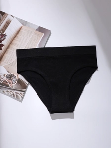 Flat lay of black low-rise cotton panties with wide waistband and seamless finish