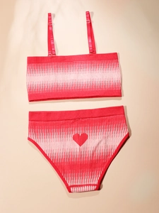 Detail of red seamless lingerie set with white vertical stripes and heart pattern on back