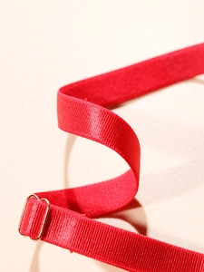 Detail of red ribbed lingerie strap with high-quality gold metal adjustment buckle