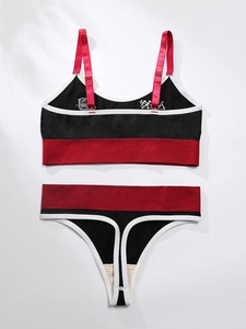 Detail of color-block sports lingerie set with racing motifs and adjustable straps