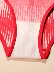 Close-up of red seamless bra set fabric with geometric knit texture and soft cotton gusset