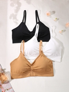 Detail view of thin straps and ribbed texture on three seamless wireless sports bras
