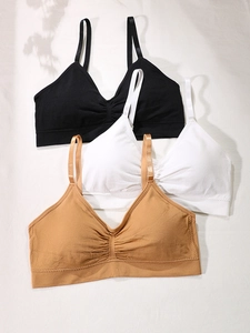 Three-pack of seamless bras in black, white, and nude with delicate ruched front detail