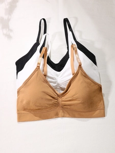 Three-pack of thin seamless sports bras in black white and coffee with ribbed band
