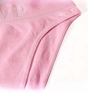 Detail of pink cotton underwear featuring elastic LOVE waistband and durable stitched edges