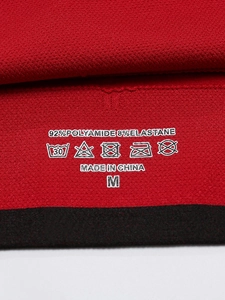 Detailed fabric label of red sports bra made of 92% Polyamide and 8% Elastane