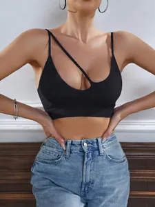 Close-up of black ribbed sports bra featuring thin straps and asymmetric cutout detail