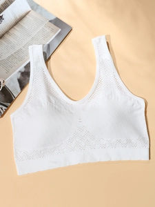 Close-up of white seamless sports bra with breathable mesh and ribbed texture detail
