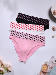 Detailed view of three seamless heart print panties in pink, white, and black colors