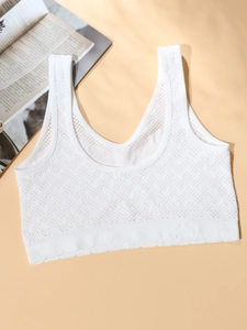 Detail of white mesh knit sports bra with breathable wavy texture and wide straps