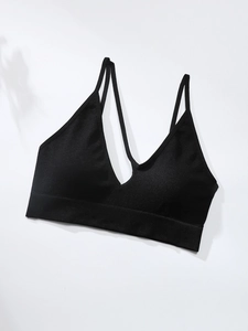 Close-up of seamless black ribbed sports bra with deep V-neck and thin straps design