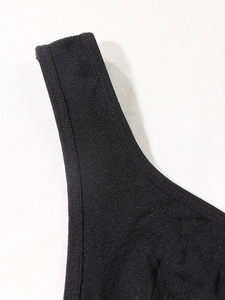 Close-up of black slimming body shaper vest with seamless edges and knitted texture