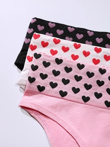Close-up of three seamless cotton panties with heart patterned elastic waistbands