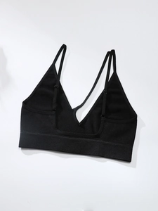 Detail view of black seamless ribbed sports bra featuring thin straps and V-neckline