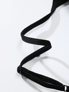 Detailed close-up of adjustable strap on black seamless sports bra with fine stitching