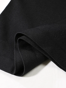 Macro shot of black rib-knit fabric detail showing premium texture for body shaper vest
