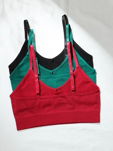 Dettagli di reggiseni sportivi senza cuciture rosso verde e nero con motivi a costine