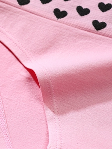 Close-up of pink high waist cotton panties showing seamless heart print and fine stitching