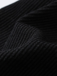 Detailed close-up of premium black ribbed knit fabric on a seamless sports bra