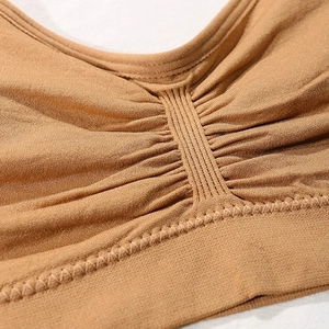 Seamless wireless sports bra in dark camel featuring a ruched front and ribbed band detail
