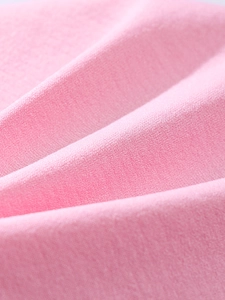 Close-up of soft pink fleece fabric detail showing plush texture and high-quality material