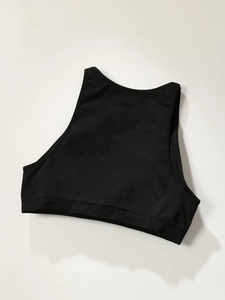 Close-up of black sports bra crop top with ribbed elastic band and seamless knit texture