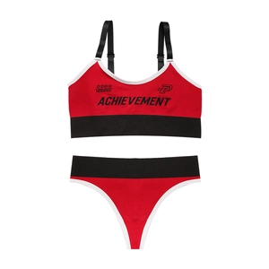 Seamless red sports bra and thong set with black adjustable straps and ribbed fabric