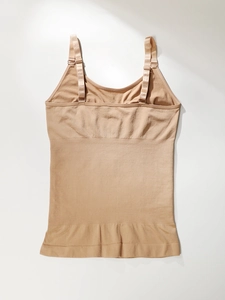 Detail of adjustable metal buckles and seamless ribbed texture on beige shapewear camisole