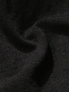 Macro shot of high-impact black sports bra fabric with glitter texture and matte finish