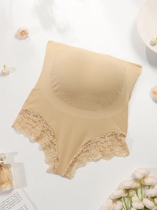 Detail of high waist seamless maternity briefs with elegant floral lace trim in beige