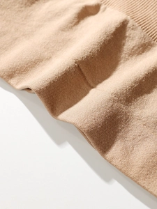 Macro shot of seamless beige shapewear fabric with breathable honeycomb texture and ribbed hem