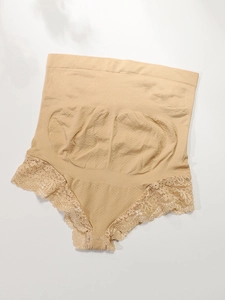 Close-up of high waist maternity briefs with delicate floral lace trim in skin color