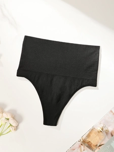 Detailed flat lay of high waist black thong featuring seamless ribbed tummy control fabric