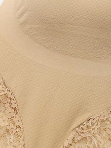 Macro detail of breathable nude maternity panties with lace trim and geometric knit texture