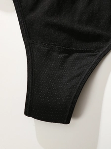 Macro detail of breathable fabric texture and durable double stitching on black thong