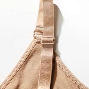 Adjustable shoulder strap detail on seamless beige slimming vest with reinforced stitching