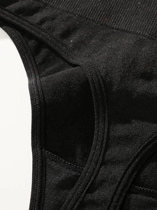 Detail of high waist seamless black thong featuring ribbed waistband and stitching