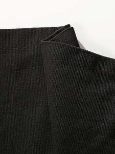 Detailed macro view of black high-elastic ribbed knit fabric with seamless vertical texture