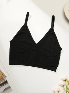 Detail showing the thin straps and wide elastic hem of this black V-neck sports bra
