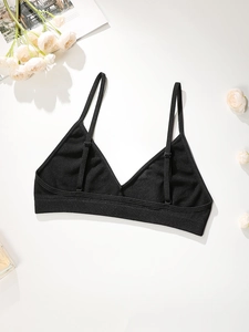 Bralette triangle noire à bretelles réglables et bande côtelée sur fond blanc épuré